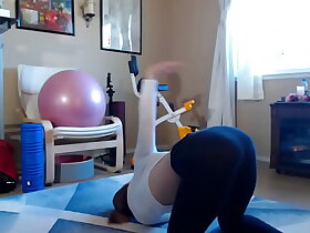 Grown up European dame stretches alongside yoga pants